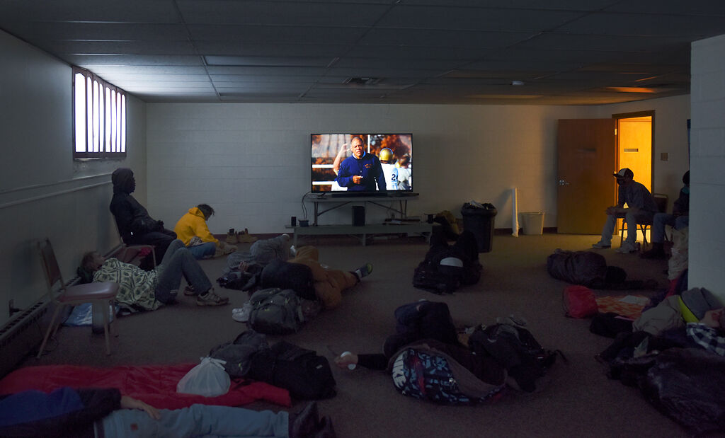 Visitors of the warming center watch